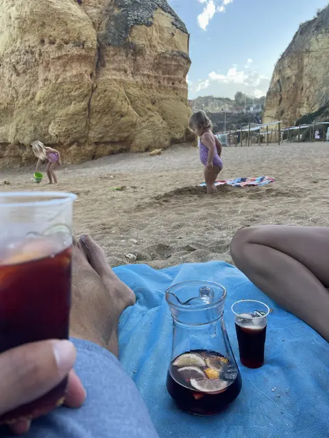 Our two daughters playing on a Lagos beach below golden cliffs in September