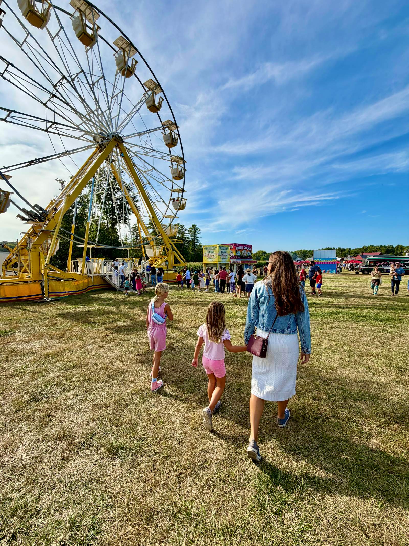 Kailah and the girls walking toward the Ferris wheel at a New Hampshire fall fair