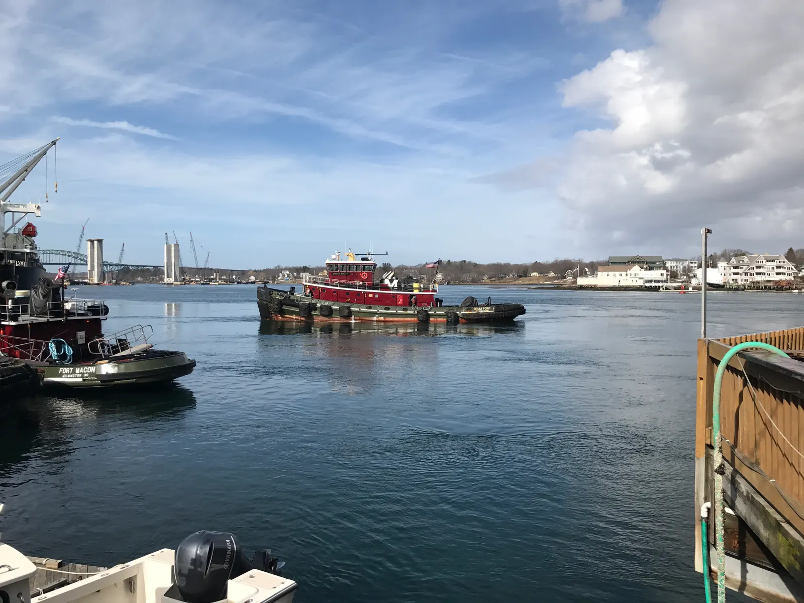 A red tugboat crossing the Piscataqua River off the Portsmouth, NH waterfront