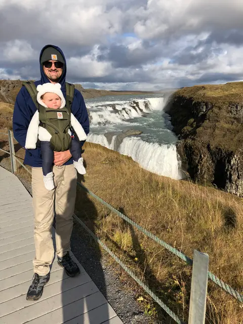 Kyle carrying our baby on the boardwalk above Gullfoss, Iceland